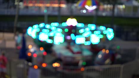 colorful ride at night in amusement park with bright lights