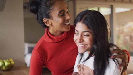 Video-of-happy-biracial-female-friends-embracing-and-kissing