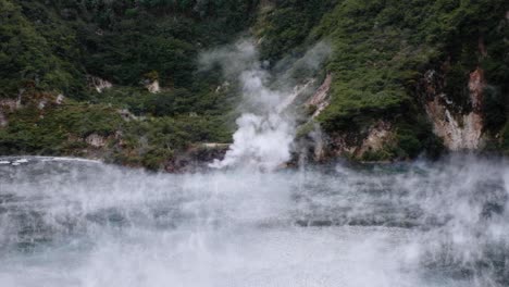 clouds of hot steam drifting over sulphuric hot pool of frying pan lake in waimangu volcanic rift valley, rotorua, new zealand aotearoa