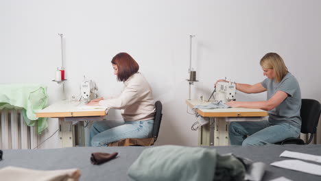 women sewing on electronic machines in professional environment, creating garments with focus, synergy, detail, demonstrating skill, collaborating side by side, ensuring high quality in production