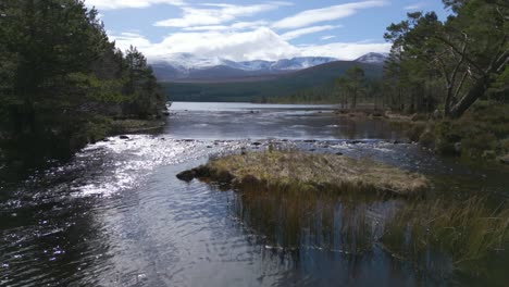 Low-flight-over-waters-of-Loch-Morlich,-Scotland