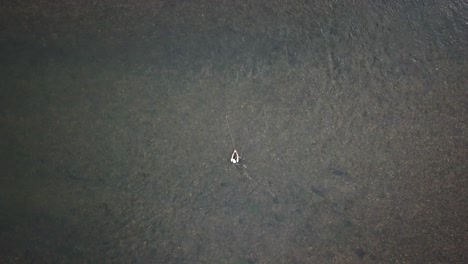 Bird's-Eye-Drone-Shot-above-a-man-Fly-Fishing-in-the-Provo-River-in-the-Mountains-of-Utah