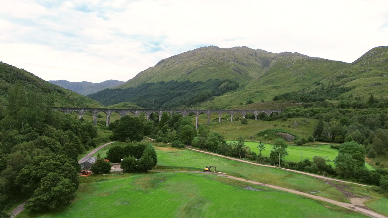 Aerial: Glenfinnan Viaduct during the day at Glenfinnan, in the Lochaber district of north-western Scotland, UK, establishing drone shot