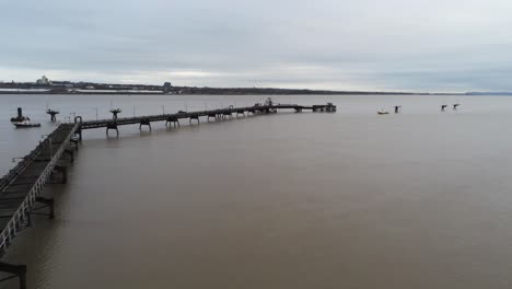 Drone-view-Tranmere-oil-terminal-Birkenhead-coastal-petrochemical-harbour-distribution-overfly-orbit-over-pipeline