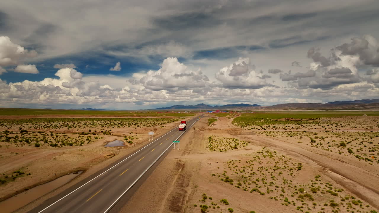 Tanker truck on Bolivian highway imports and delivers gasoline from Chile, drone