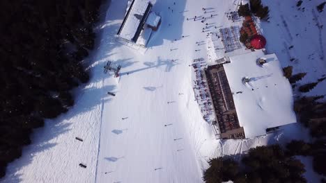 Aerial-drone-video-of-crowded-ski-restaurant-with-terrace-full-of-people