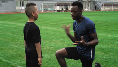 soccer coach training a young player