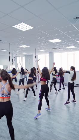 athletic women doing aerobic on a fitness center
