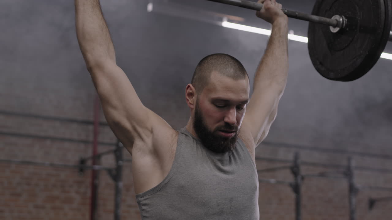 Sportsman Lifting Weights in Gym