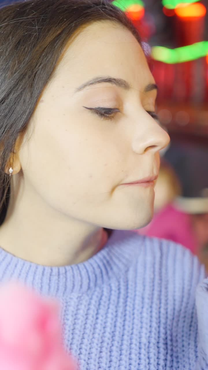 Close-up Portrait of a Young Woman in a Purple Sweater