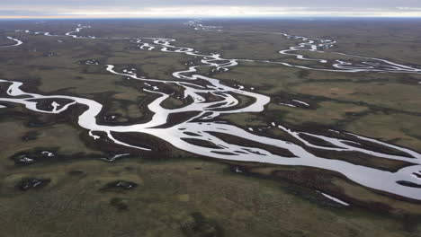aerial view of a braided river system in a vast flat landscape