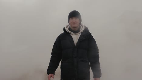 Man-go-through-dense-steam-cloud-at-Myvatn-geothermal-area,-Iceland