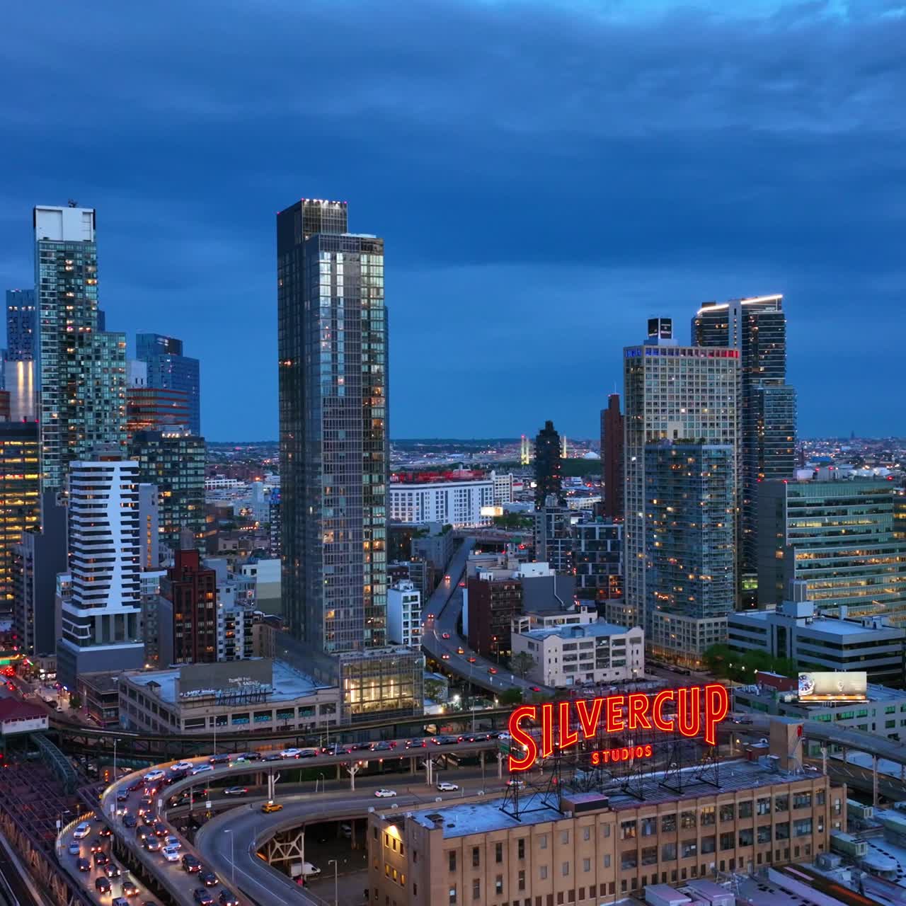 Well-known film Silvercup Studios in New York. Fantastic city architecture with evening lights. Blue sky background