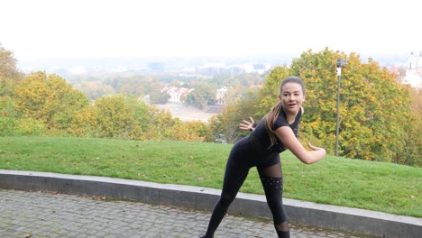 Beautiful-female-dancer-dancing-outside-in-a-sunny-city