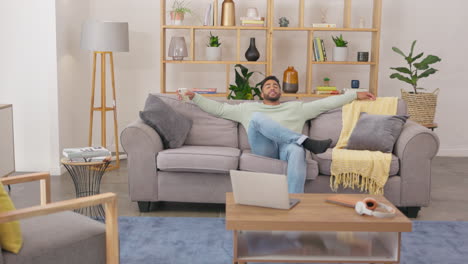 happy, phone and man relax on sofa at home