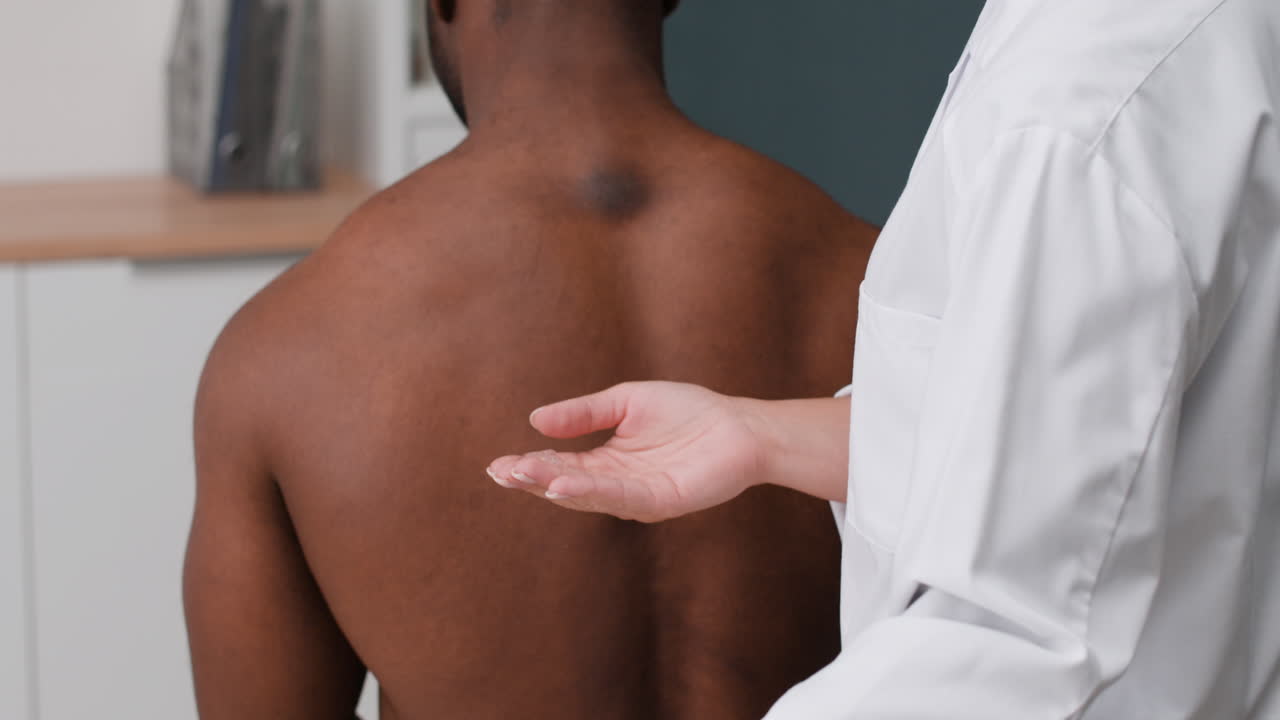 Doctor examining patient's back