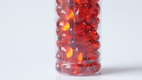 red capsules in a transparent bottle