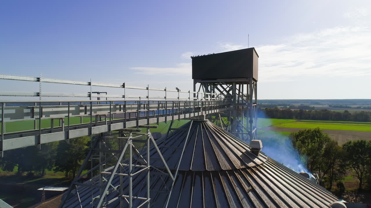 Aerial view of metal grain elevator in agricultural zone. Grain warehouse