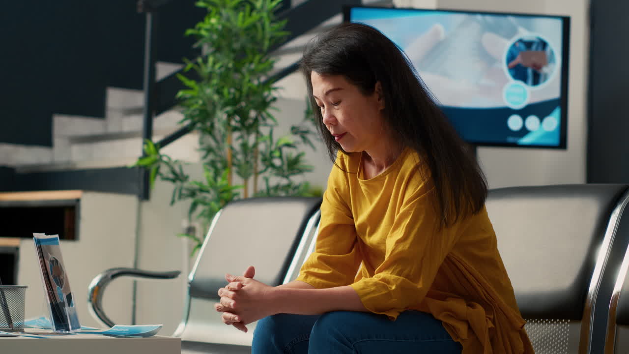 Asian woman waiting in hospital waiting room