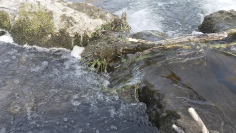 high angle look at water flowing over rocks on the river wye in bakewell