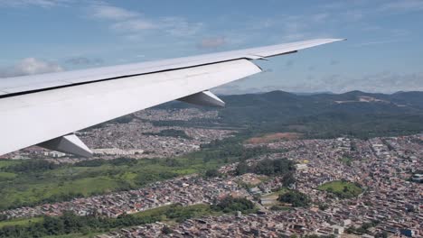 airplane with extended flaps in approach for landing - passenger view