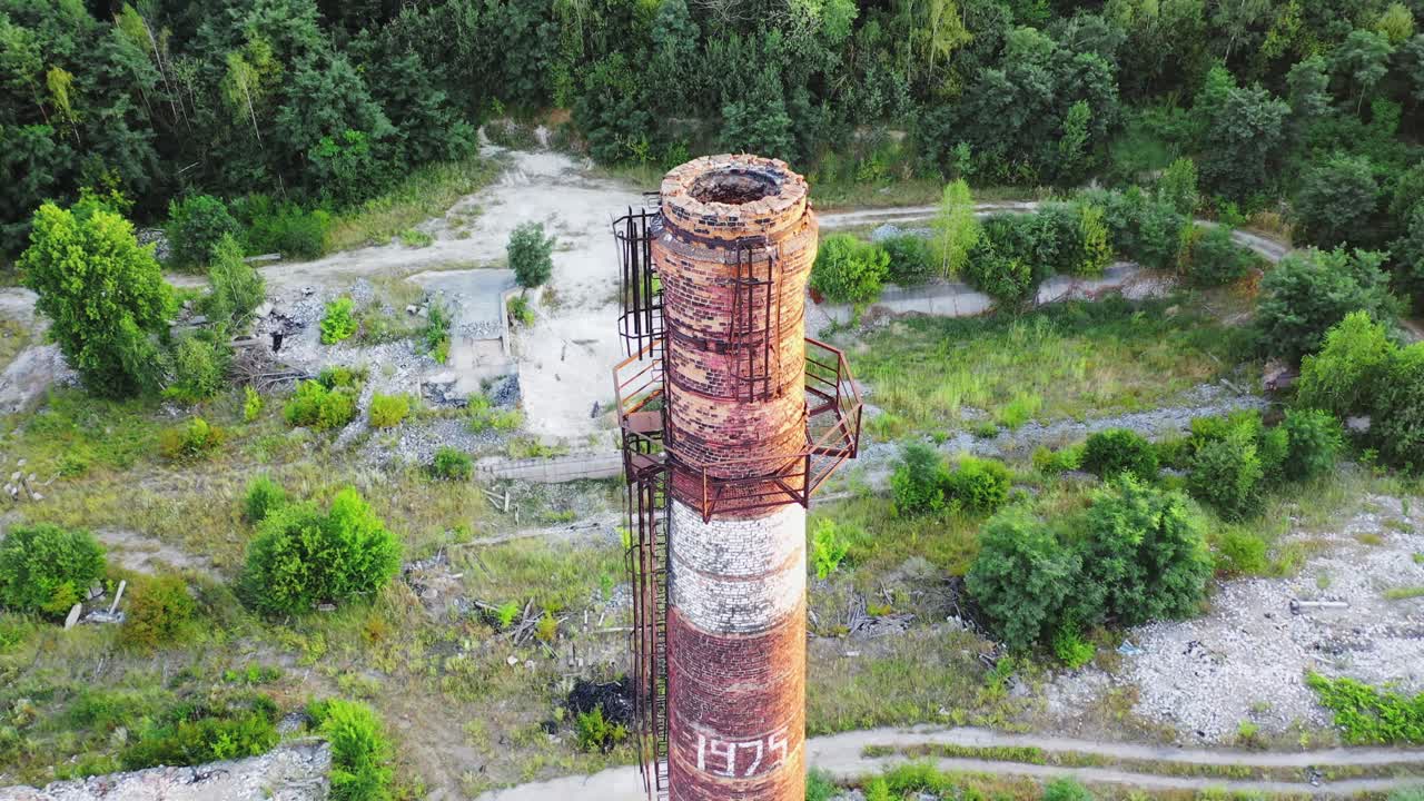Wooden logs in bright flame. Smoldered logs with sparks in campfire. Wooden stick turning over wooden embers in orange flame. Close-up.