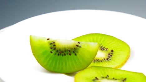 fresh kiwi slice is slowly rotating in the studio with the details.