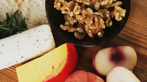 bowl of green olives, spices, crispy biscuits, jam, rosemary herb, cheese and walnuts