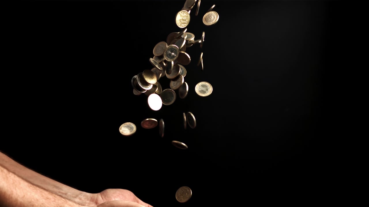 Slow Motion Euro Coins Falling and Floating Above Cupped Hands