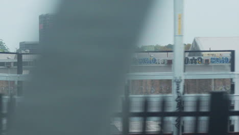 filming out of a train window during the early dawn passing an industrial estate in sydney australia