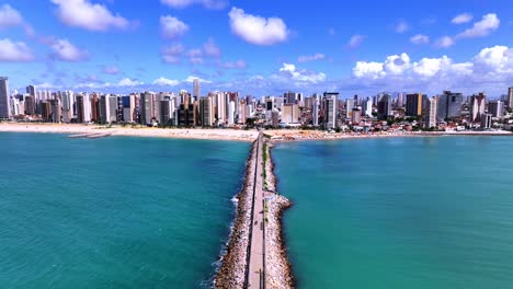 aerial view of fortaleza's iracema beach, brazil, showcasing tourists strolling on iconic pier enjoying vibrant scene