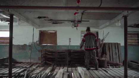 man taking out the old wooden pallet
