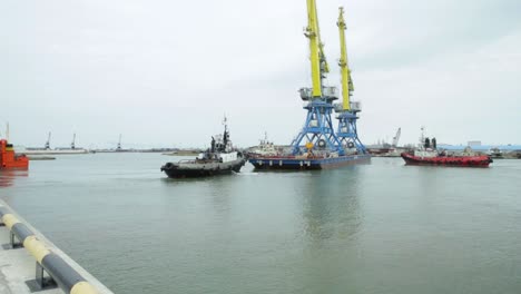 port operations with tugboats and cranes