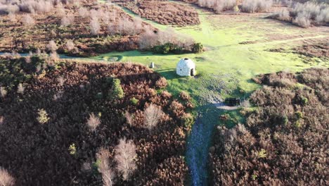 4K-Aerial-fast-ascent-from-structure-exposing-the-beautiful-forest-and-rolling-hills-of-Culmstock-Beacon-in-the-Blackdown-Hills-of-Devon-England