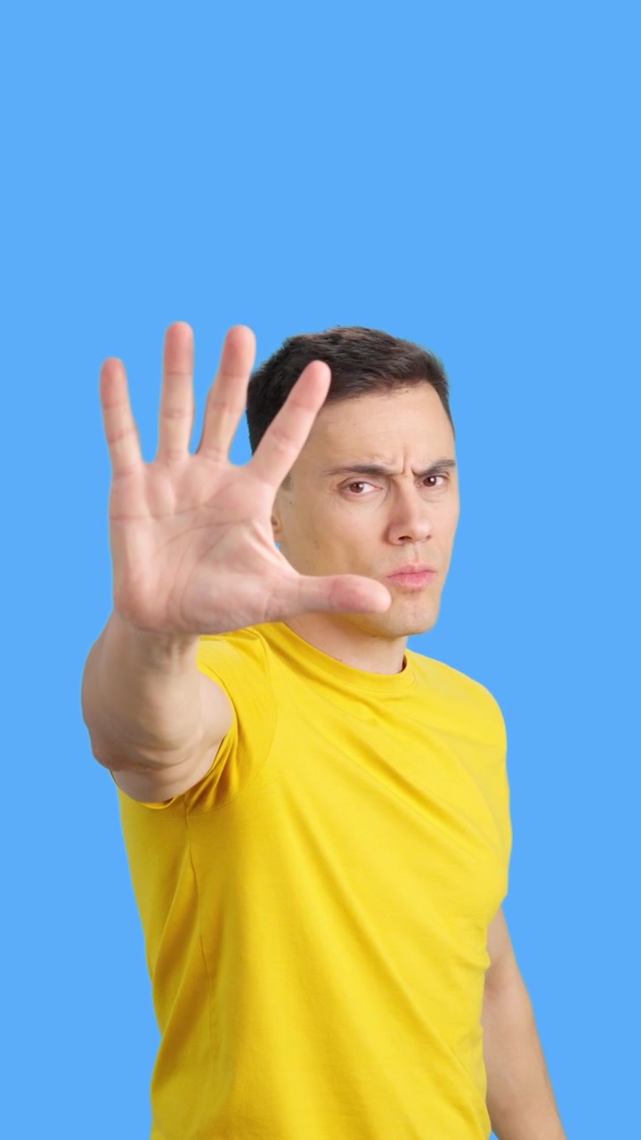 Man with hand raised in a stop gesture