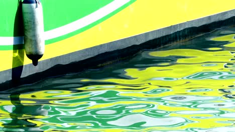 detail of boat with reflections in the sea.