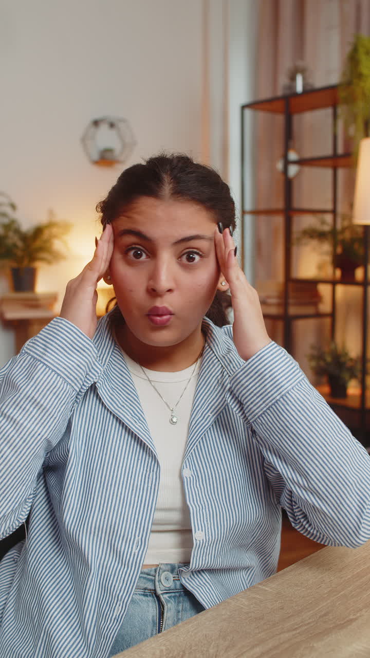 Stress young woman dissatisfied looking at camera shake head no rejection deny at table at home