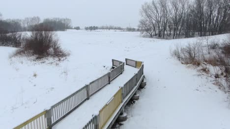 Rückwärts-Fliegende-Antenne-Einer-Langlauf-Skibrücke-In-Einer-Parkähnlichen-Umgebung-Mitten-Im-Winter