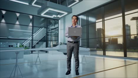 man with laptop in modern futuristic office