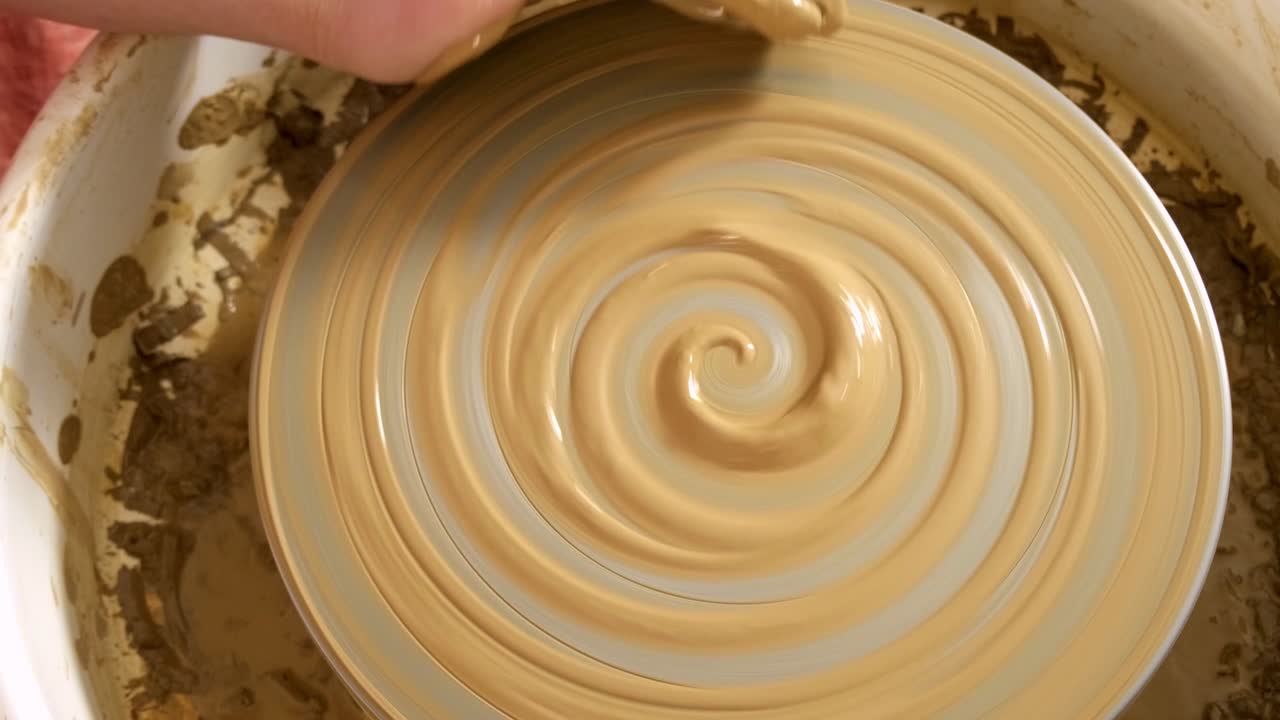 Creating Beautiful Pottery: The Art of Throwing Clay on a Pottery Wheel Demonstrated Through Two Key Frames Capturing the Transformation of a Clay Form