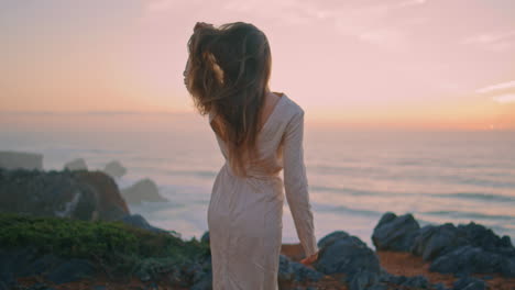 tender woman standing evening hill at ocean view closeup. model looking camera