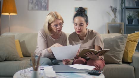 women doing financial paperwork together