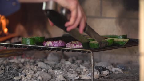 cooking turning vegtables on barbacue with a cooking fork