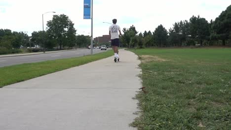 a man passing by on an electric scooter in denver