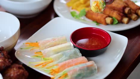 spring rolls with dipping sauce, no visible action