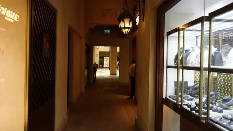 a person walks through a market hallway