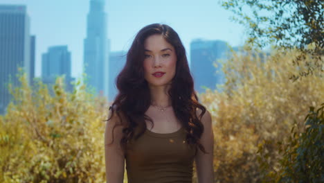 asian young woman standing in park closeup. portrait of model posing on nature.