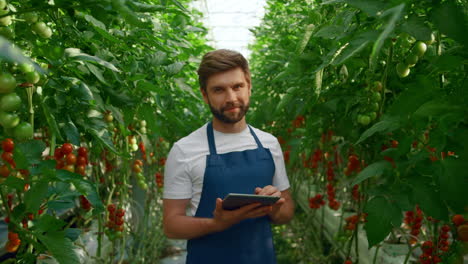 man farmer collecting cultivation research modern device in big plantation