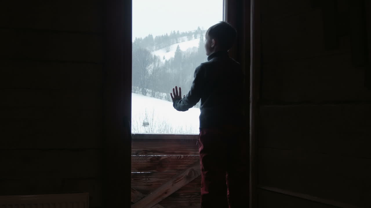 The Child Looks At Snow Through a Window (Stock Footage)
