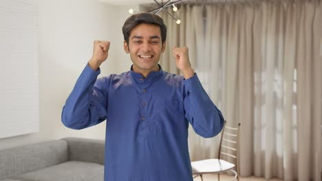 indian man cheering and congratulating